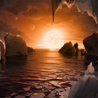 Impressão artística da superfície de Trappist-1f, um dos 7 exoplanetas que orbitam a estrela Trappist-1, uma anã vermelha extremamente fria localizada a apenas 40 anos-luz da Terra. © NASA, JPL-Caltech, T. Pyle (IPAC)