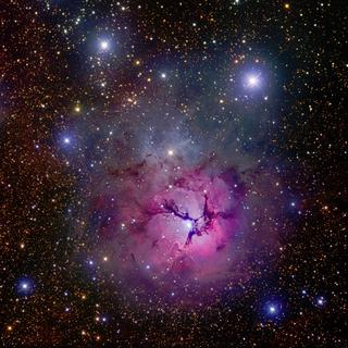 Messier 20, também conhecida como nebulosa Trífida, revela a delicadeza de suas pétalas graças a fotos tiradas por R. Hannahoe na Austrália, montadas e processadas por Robert Gendler. Crédito R. Gendler