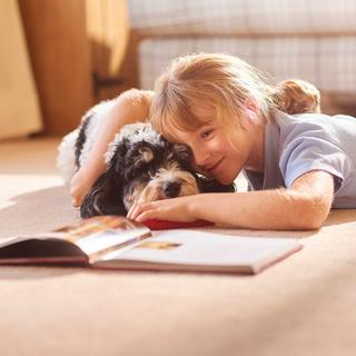 La présence du chien offre un moment de bien-être à l’enfant. ©&nbsp;sturti, iStock