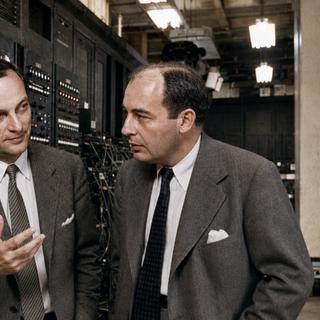 Le mathématicien hungaro-américain John von Neumann est la première personne connue à avoir évoqué une « singularité » dans le progrès technologique. Son collègue et ami ukraino-polonais Stanislaw Ulam rapportait en 1958 qu'une discussion antérieure avec von Neumann « portait sur l'accélération du progrès technologique et les changements dans la vie humaine, qui donnent l'impression d'approcher une singularité essentielle dans l'histoire de l'humanité au-delà de laquelle les affaires humaines, telles que nous les connaissons, ne pourraient plus se poursuivre ».&nbsp;De gauche à droite, Stanislaw Ulam&nbsp;et John von Neumann vus par l'IA devant l'Eniac (Electronic Numerical Integrator And Computer) qui est, en 1945, le premier ordinateur Turing-complet entièrement électronique. © ChatGPT