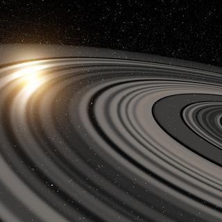 Illustration du vaste système d’anneaux qui entoure la possible super-Saturne ou naine brune J1407b. En passant devant la jeune étoile autour de laquelle elle gravite, la lumière de celle-ci est en partie occultée. © Ron Miller